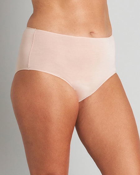 Model wears Au Naturel Full Brief in LATTE. On body side view