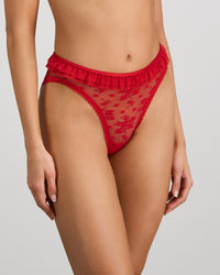 Model wears Tinsel Tease High Cut Brief in SALSA. On body side view