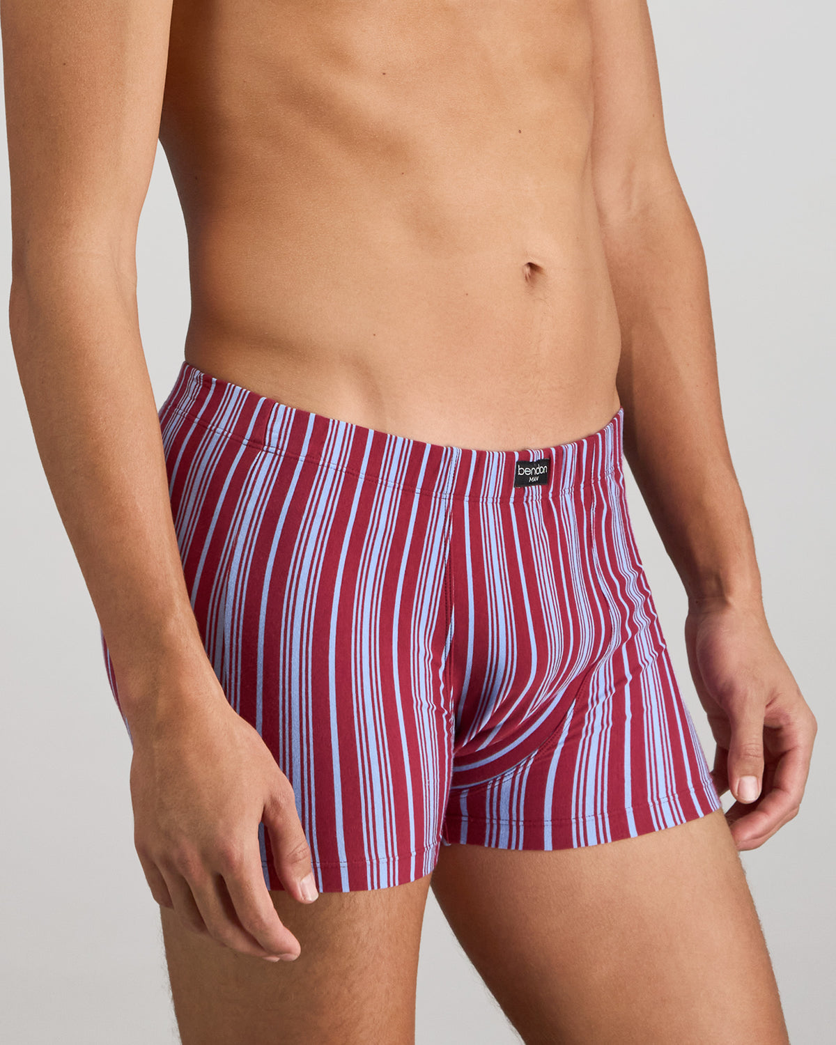 Model wears Cotton Stretch Mens Trunk in TIBETAN RED STRIPE. On body side view