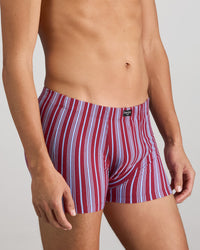 Model wears Cotton Stretch Mens Trunk in TIBETAN RED STRIPE. On body side view