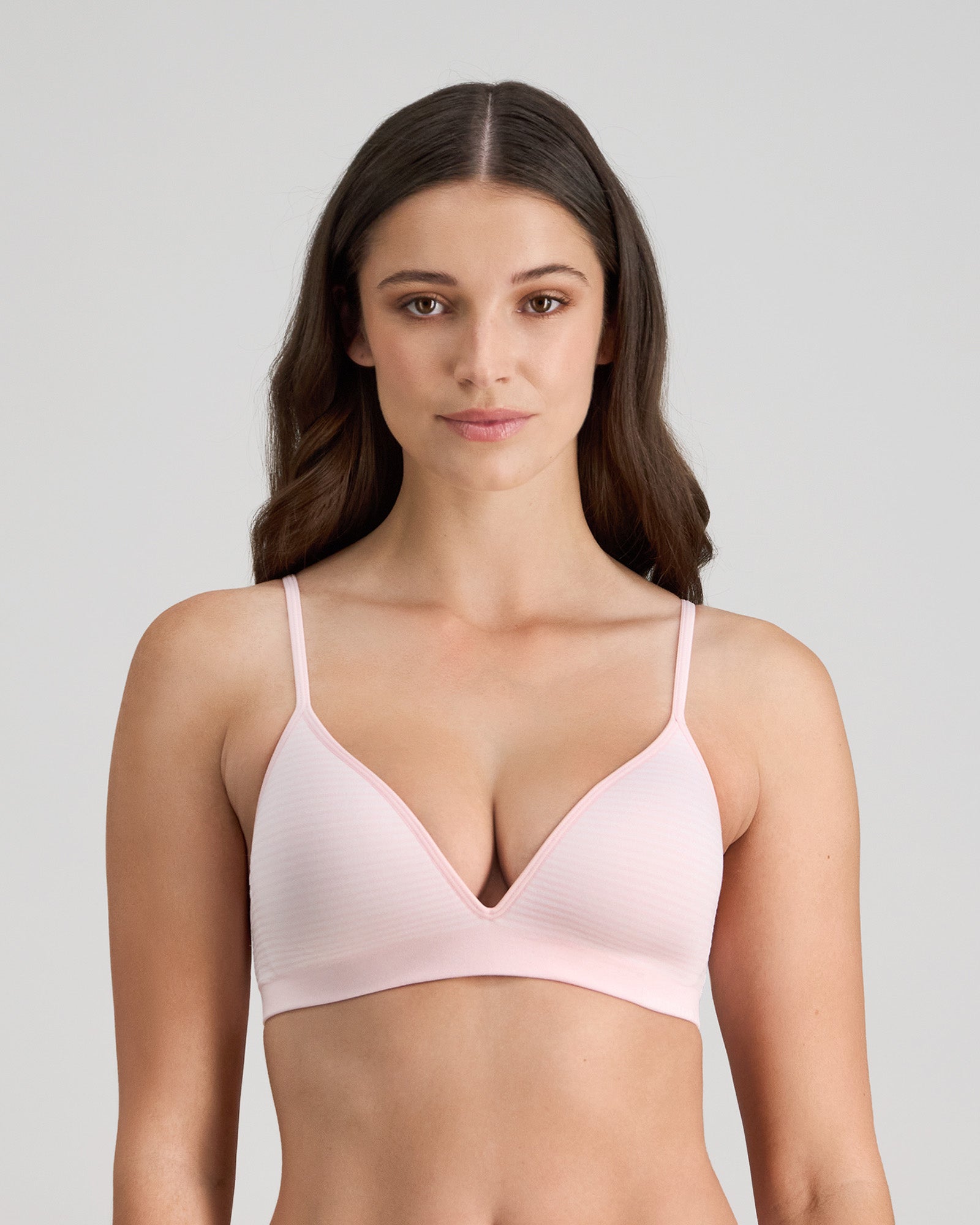 Model wears Simply Seamless Wire Free Bra in ICY PINK/WHITE STRIPE. On body front view