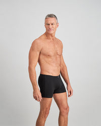 Model wears Cotton Stretch Mens Trunk in BLACK. On body side view