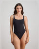 Model wears Extra-Ordinary Bodysuit in BLACK. On body front view