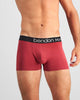 Model wears Everyday Essential Mens Trunk in TIBETAN RED. On body front view