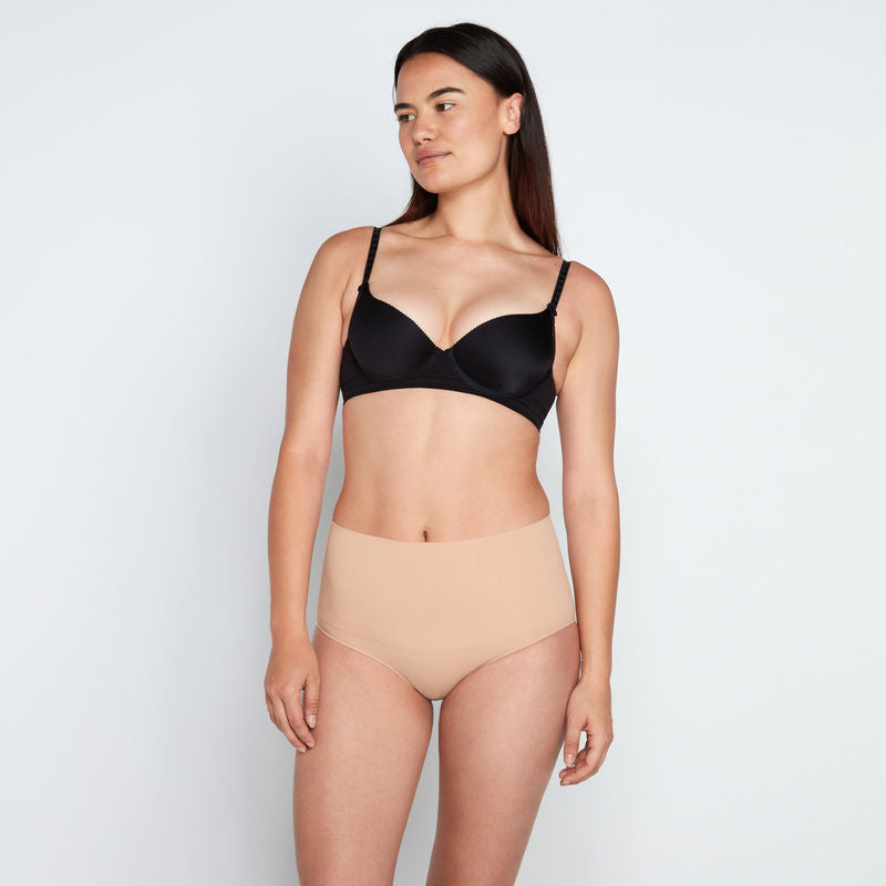 Model wears Medium Control Full Brief in CARAMEL. On body front view