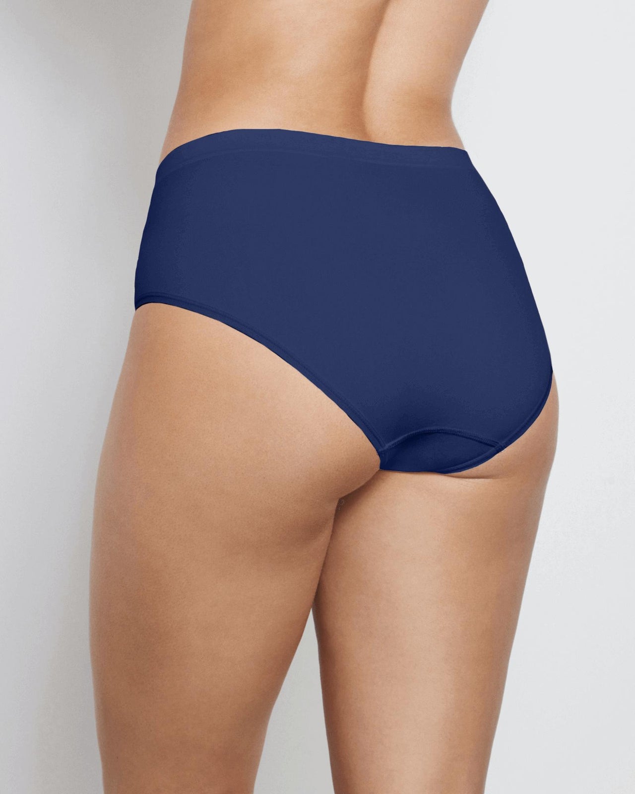 Model wears Seamless Soft Full Brief in Medieval Blue. On body back view