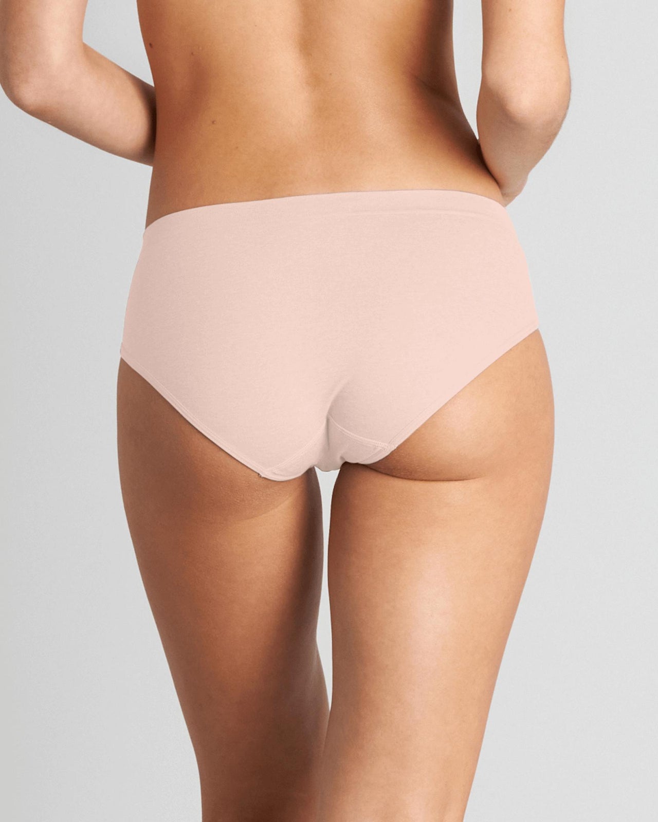 Model wears Simply Seamless Boyshort in SILVER PINK. On body back view