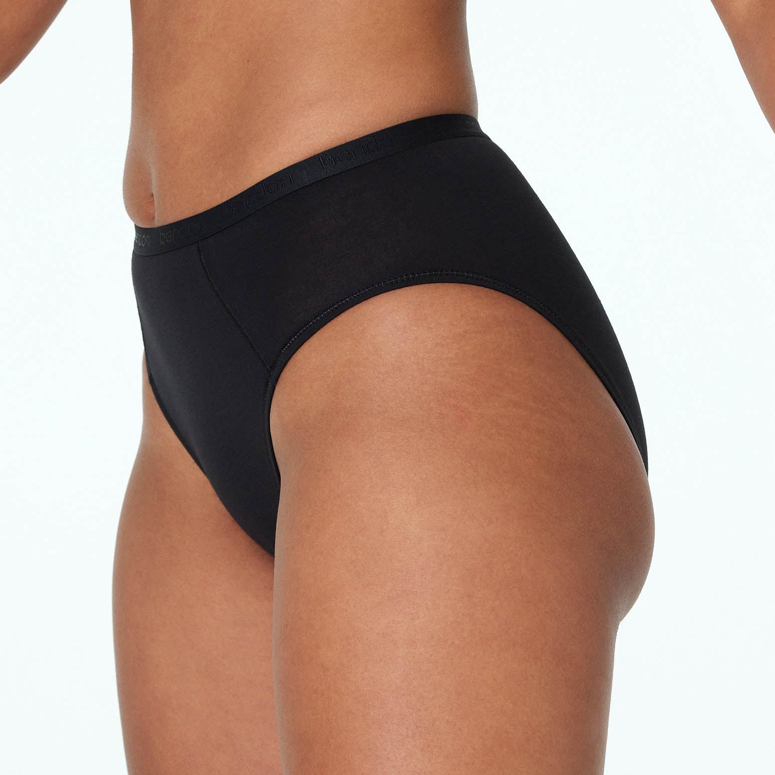 Model wears Body Cotton High Cut Brief in BLACK. On body side view