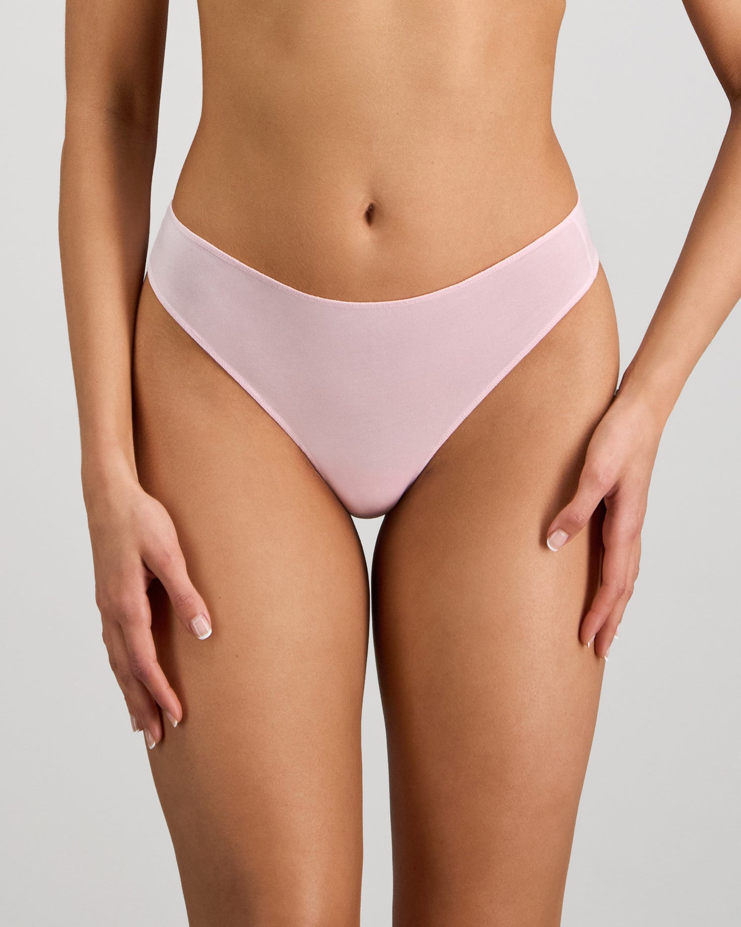 Model wears Au Naturel Thong in PALE LILAC. On body front view