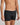 Model wears Cotton Stretch Mens Trunk in BLACK. On body side view