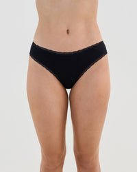 Model wears Stretch Cotton Bikini in BLACK. On body front view