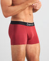 Model wears Everyday Essential Mens Trunk in TIBETAN RED. On body side view