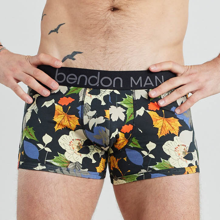 Model wears Retros Print Mens Trunk in SUMMER FOLIAGE PRINT. On body front view