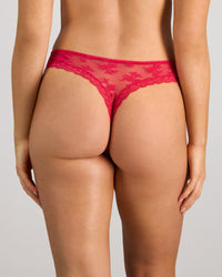 Model wears Light Lace Thong in JAZZY. On body back view