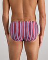 Model wears Cotton Stretch Mens Brief in TIBETAN RED STRIPE. On body back view