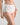 Model wears Freedom Full Brief in WHITE. On body side view