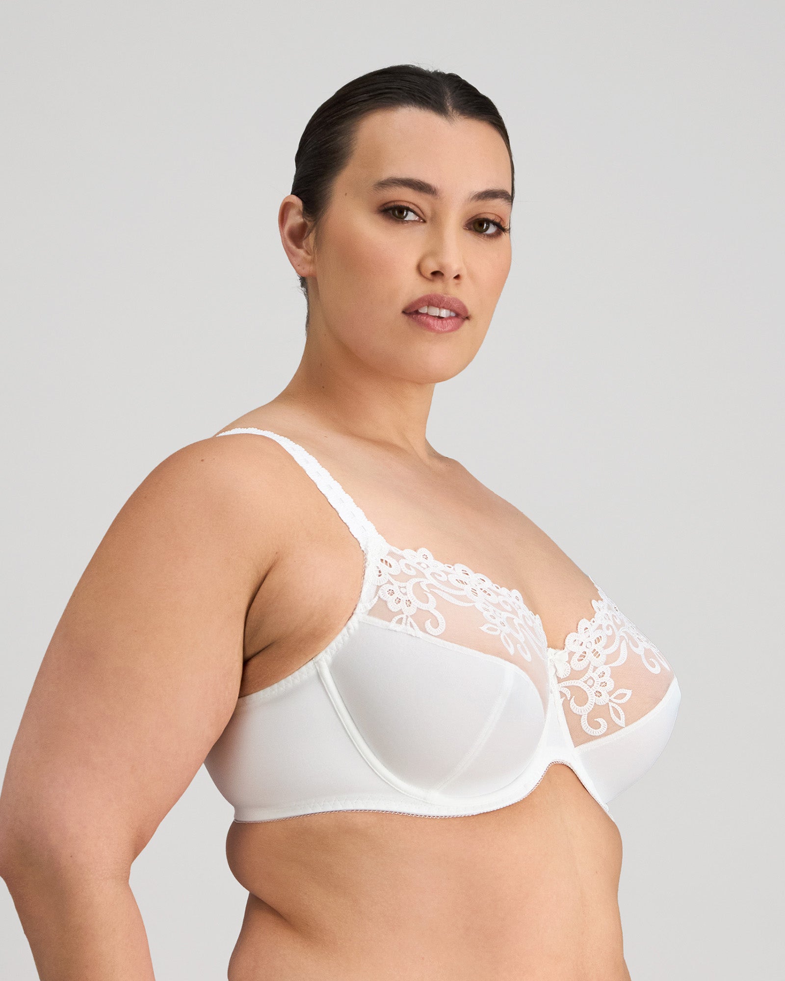 Model wears Coral Underwire Bra in WHITE. On body side view