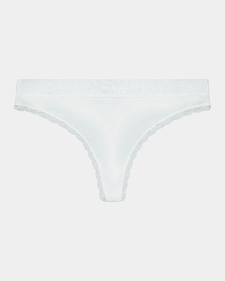 Model wears Cotton Logo Thong in WHITE. On body front view