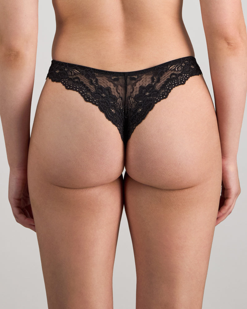 Model wears My Fit Lace Thong in BLACK. On body back view