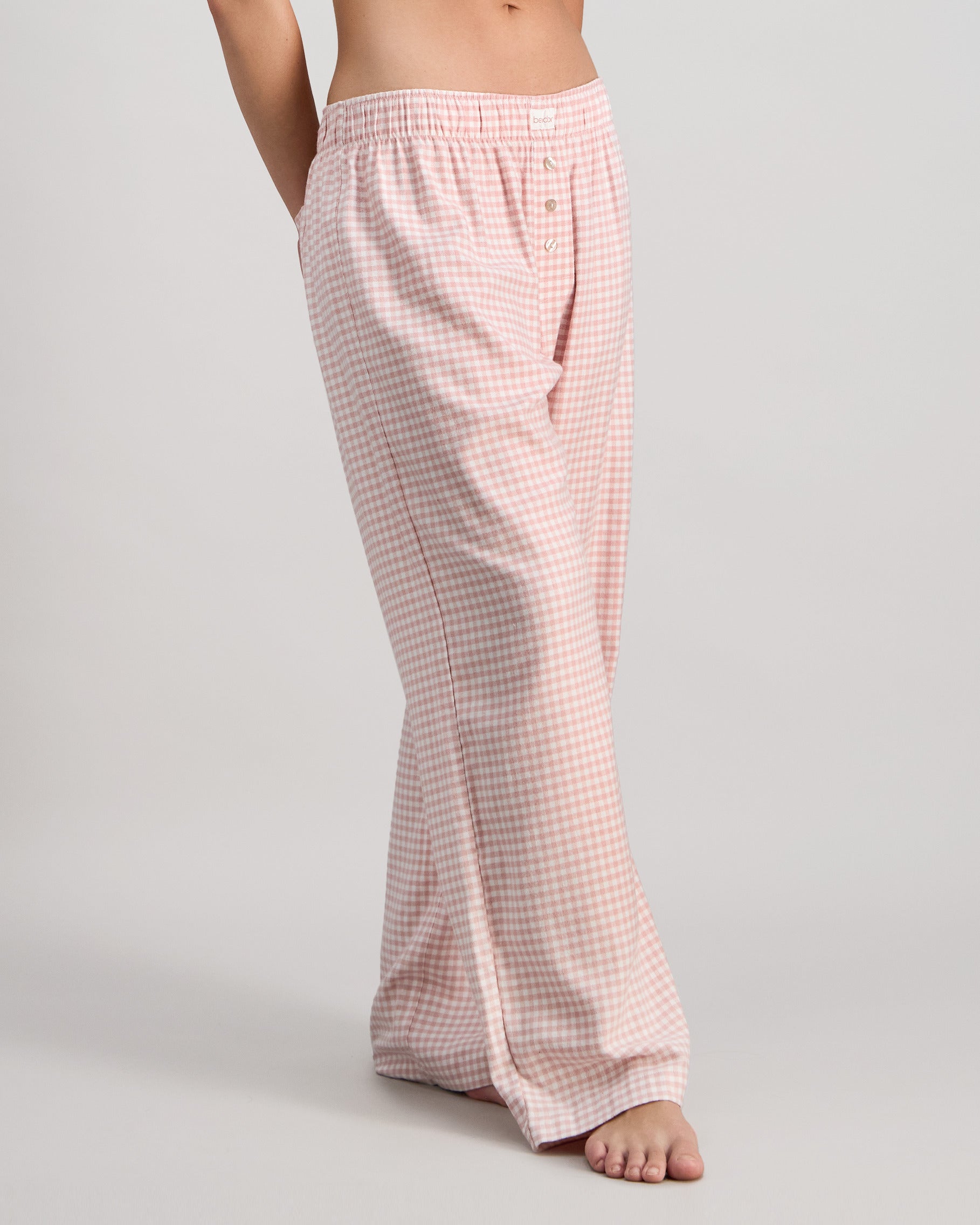 Model wears Cosy Flannel Long PJ Pant in ROSE MINI GINGHAM. On body side view