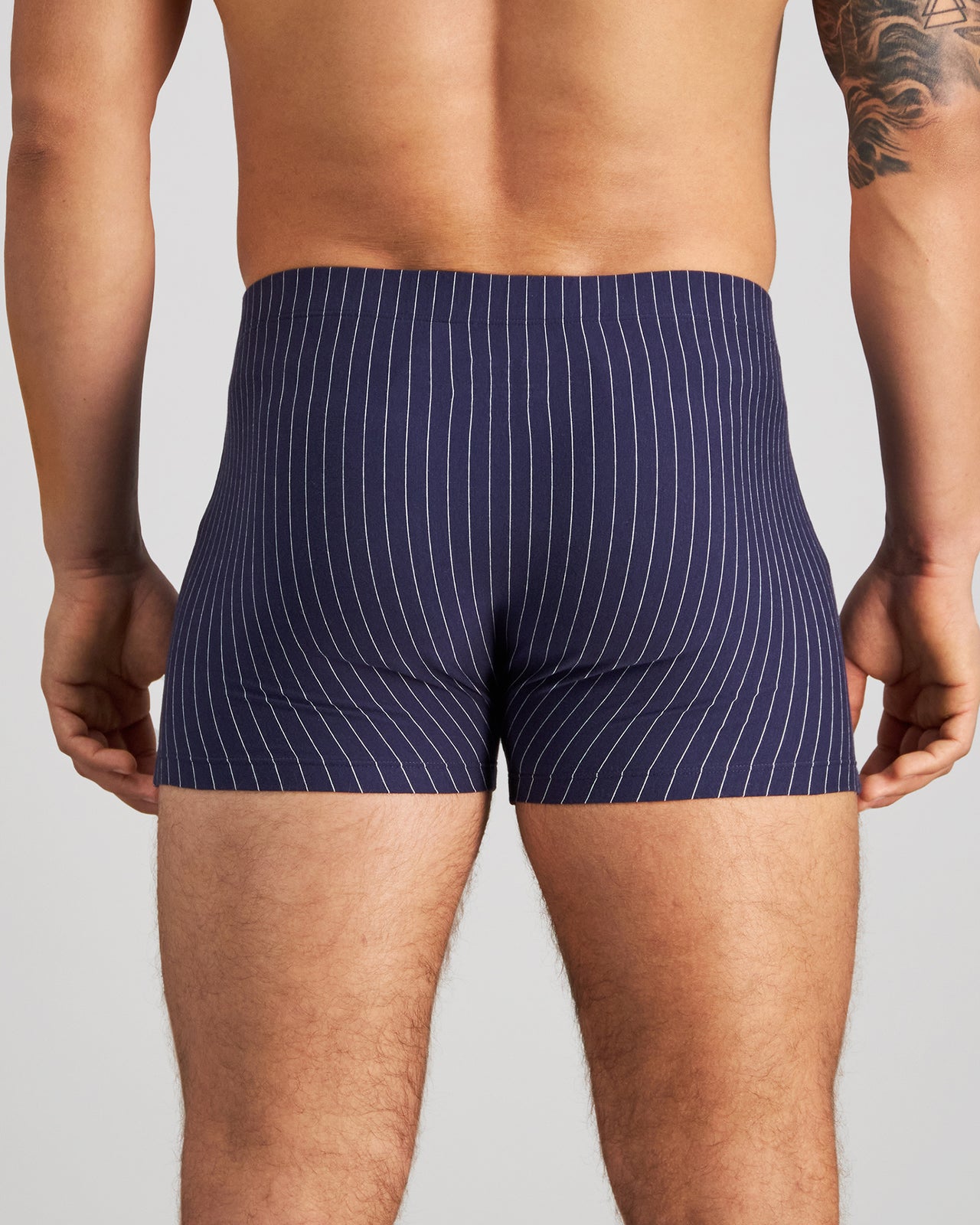 Model wears Cotton Stretch Mens Trunk in PEACOAT PINSTRIPE. On body back view