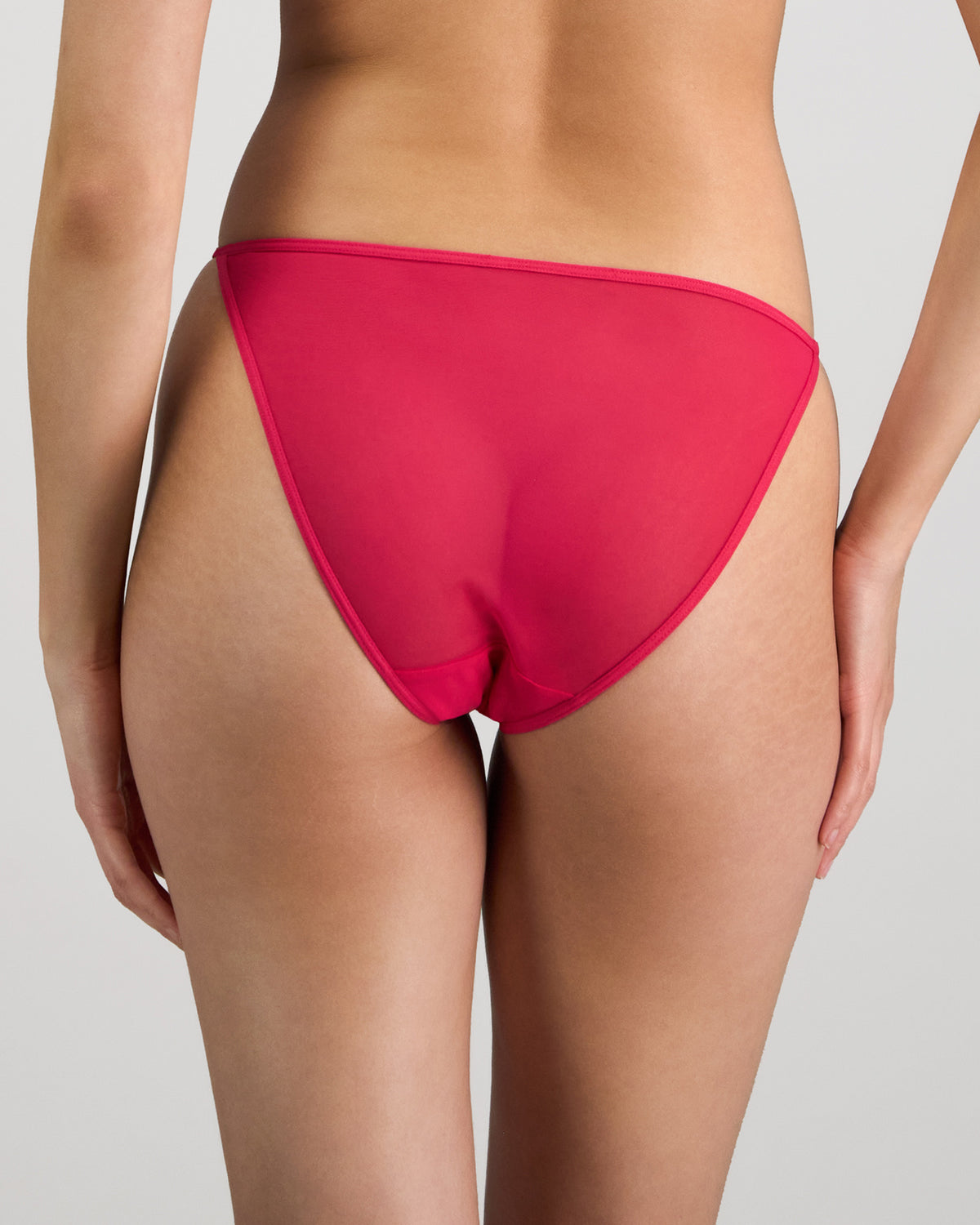 Model wears Skinlite Tanga in JAZZY. On body back view