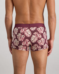 Model wears Retros Print Mens Trunk in FIG MONSTERA PRINT. On body back view