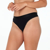 Model wears Cotton Logo Thong in BLACK. On body side view