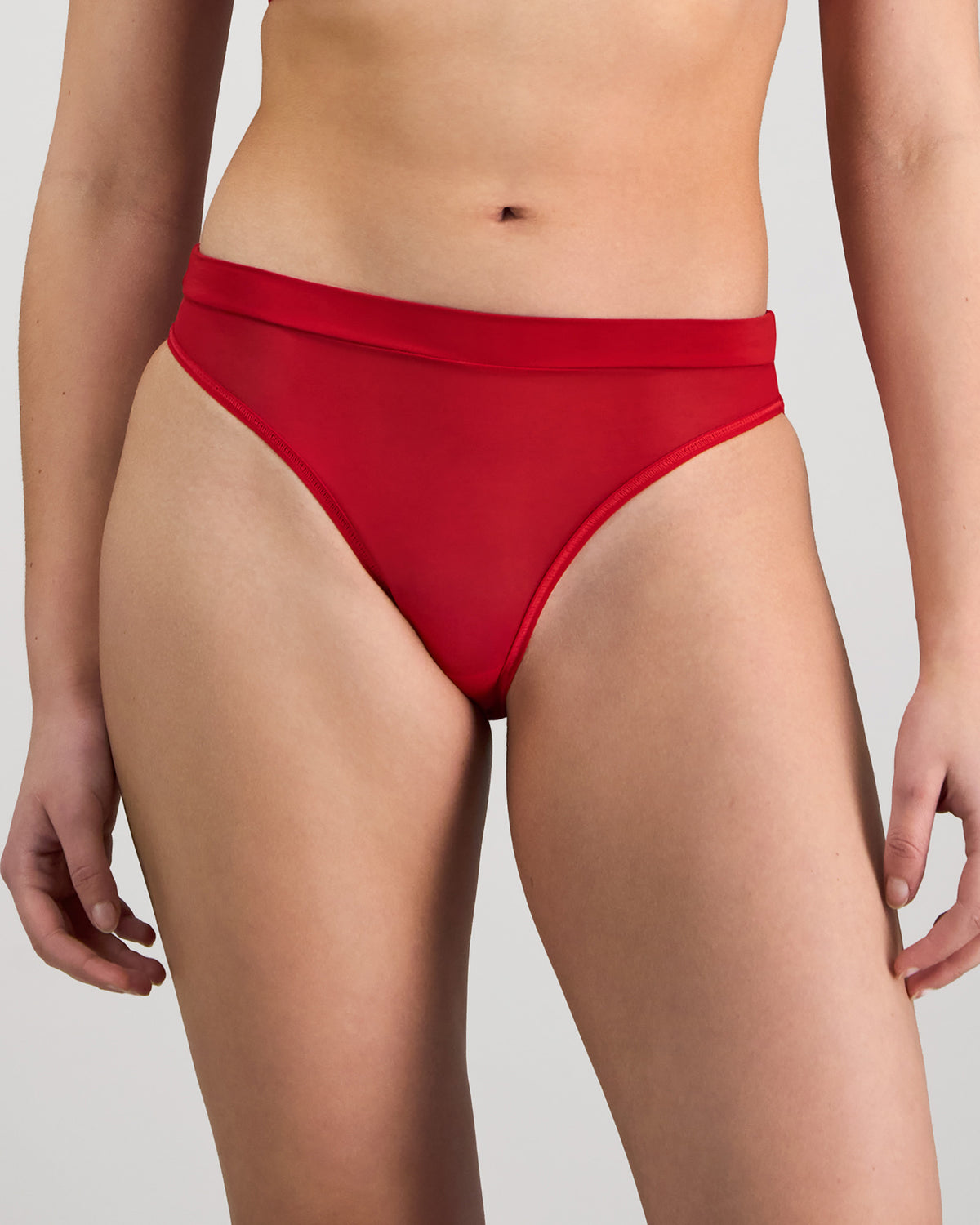 Model wears Lightweight High Cut Brief in SALSA. On body front view