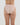Model wears Seamless Soft High Cut Brief in LATTE. On body back view