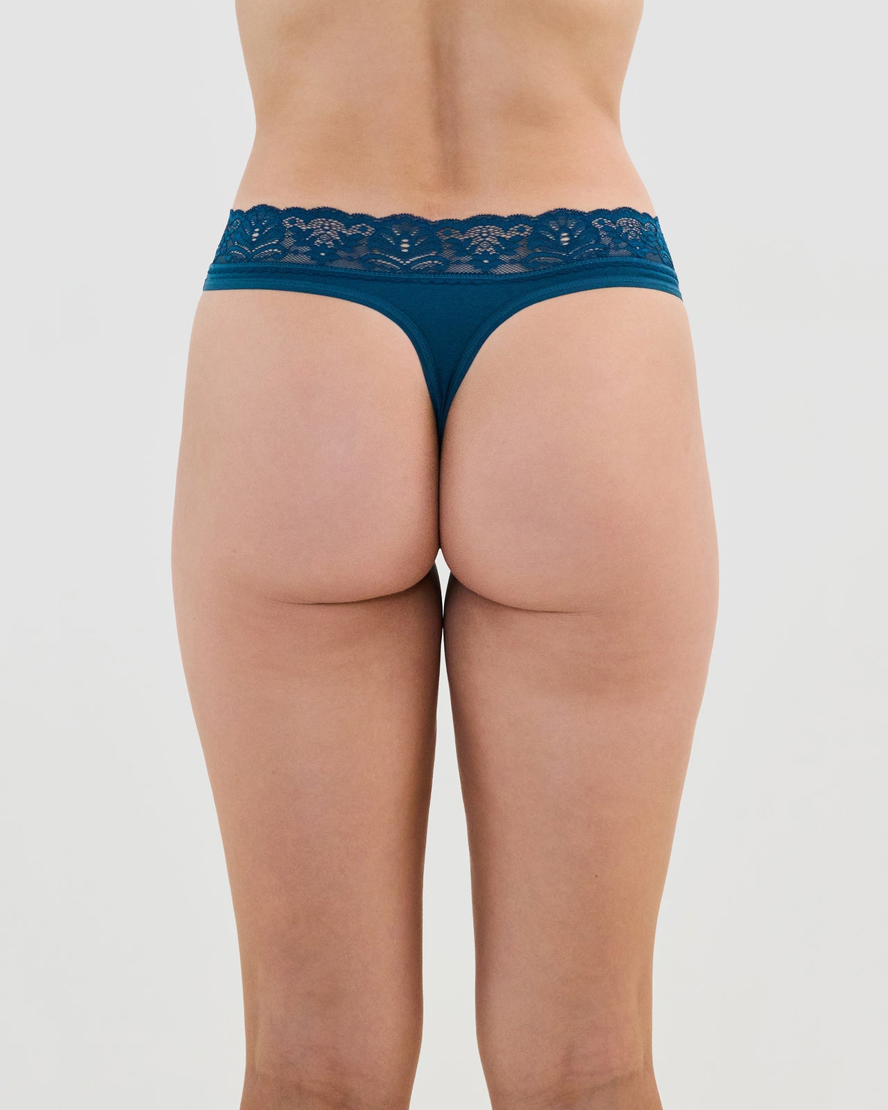 Model wears Cotton And Lace Thong in REFLECTING POND. On body back view