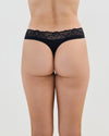Model wears Cotton And Lace Thong in BLACK. On body back view