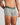 Model wears Retros Print Mens Trunk in ART DECO TILE PRINT. On body side view