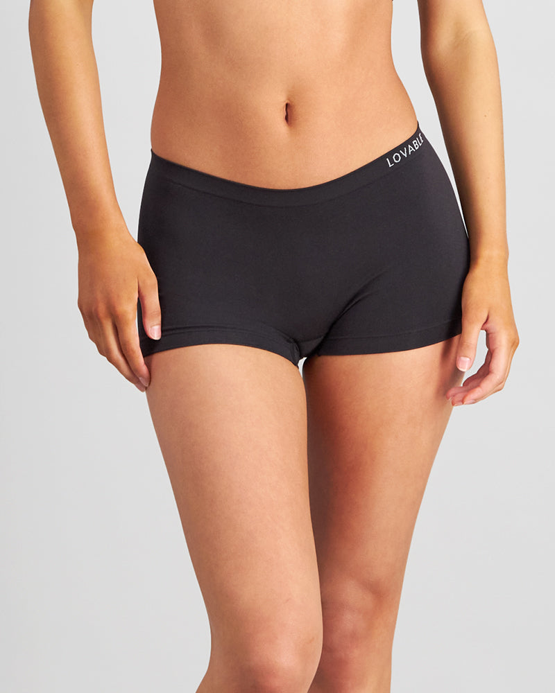 Model wears Simply Seamless Boyshort in BLACK. On body front view