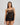 Model wears Oasis Glow Babydoll in BLACK. On body front view