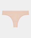Model wears Seamless Thong in LATTE. On body front view