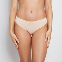 Model wears Seamless Bikini in LATTE. On body front view
