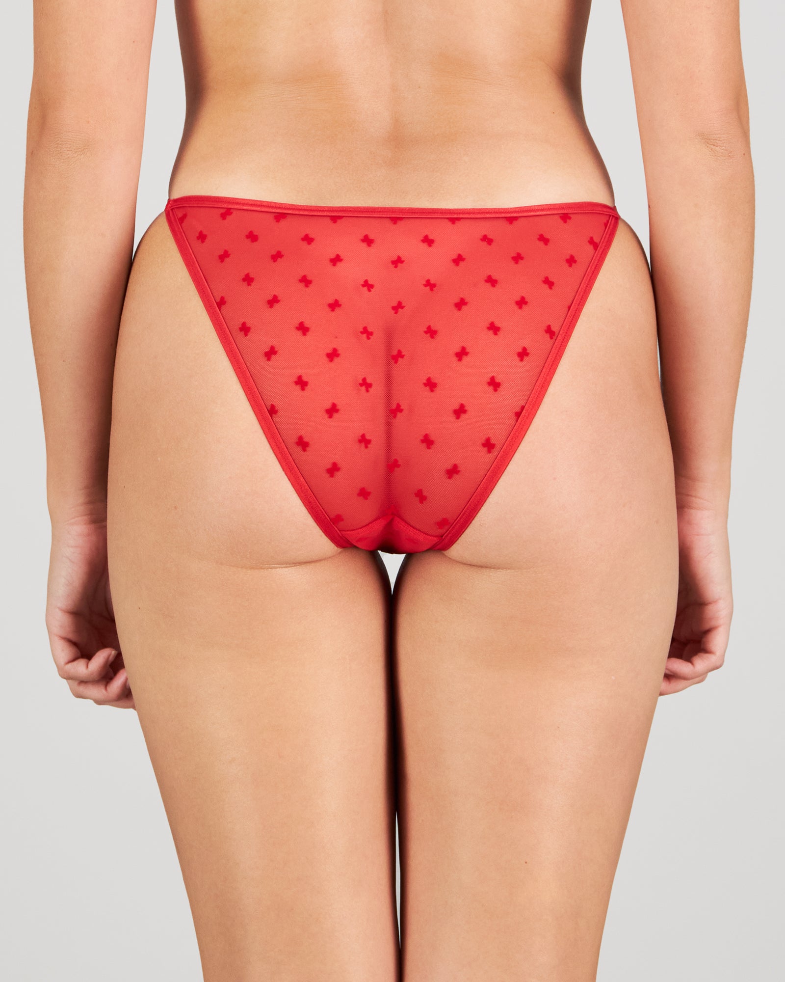 Model wears Wrapped In Bows Tanga in SALSA. On body back view