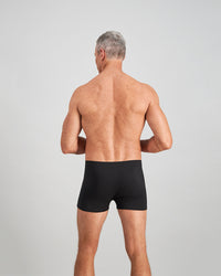 Model wears Cotton Stretch Mens Trunk in BLACK. On body back view