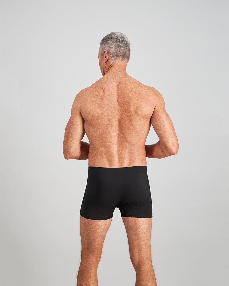 Model wears Cotton Stretch Mens Trunk in BLACK. On body back view