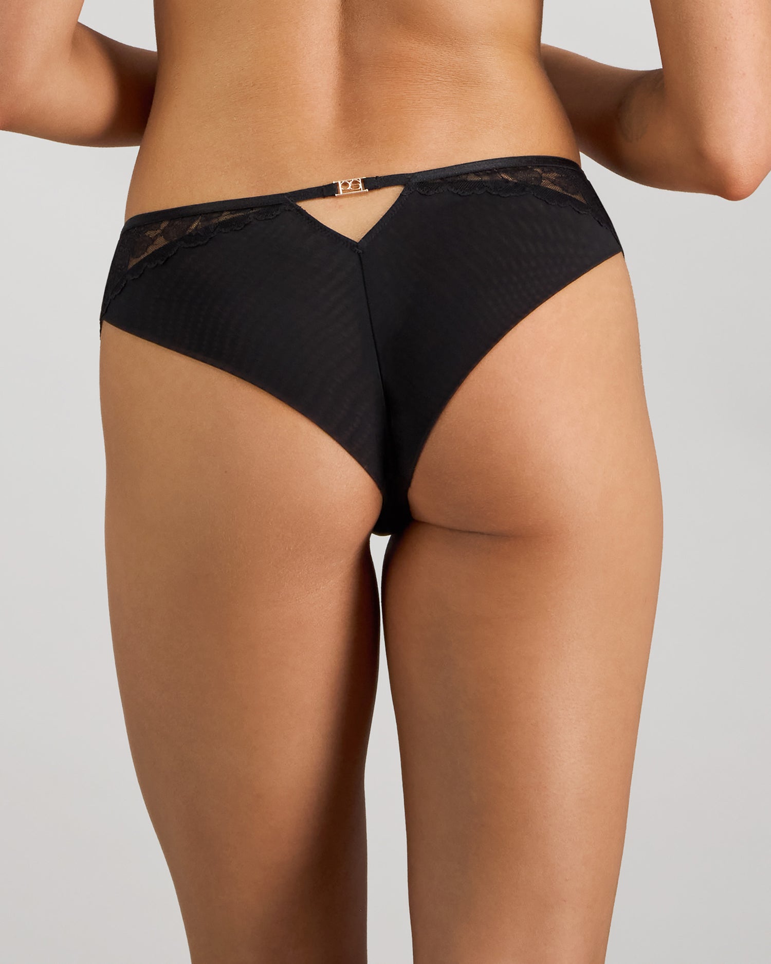 Model wears Lace Impact Brazilian in BLACK. On body back view