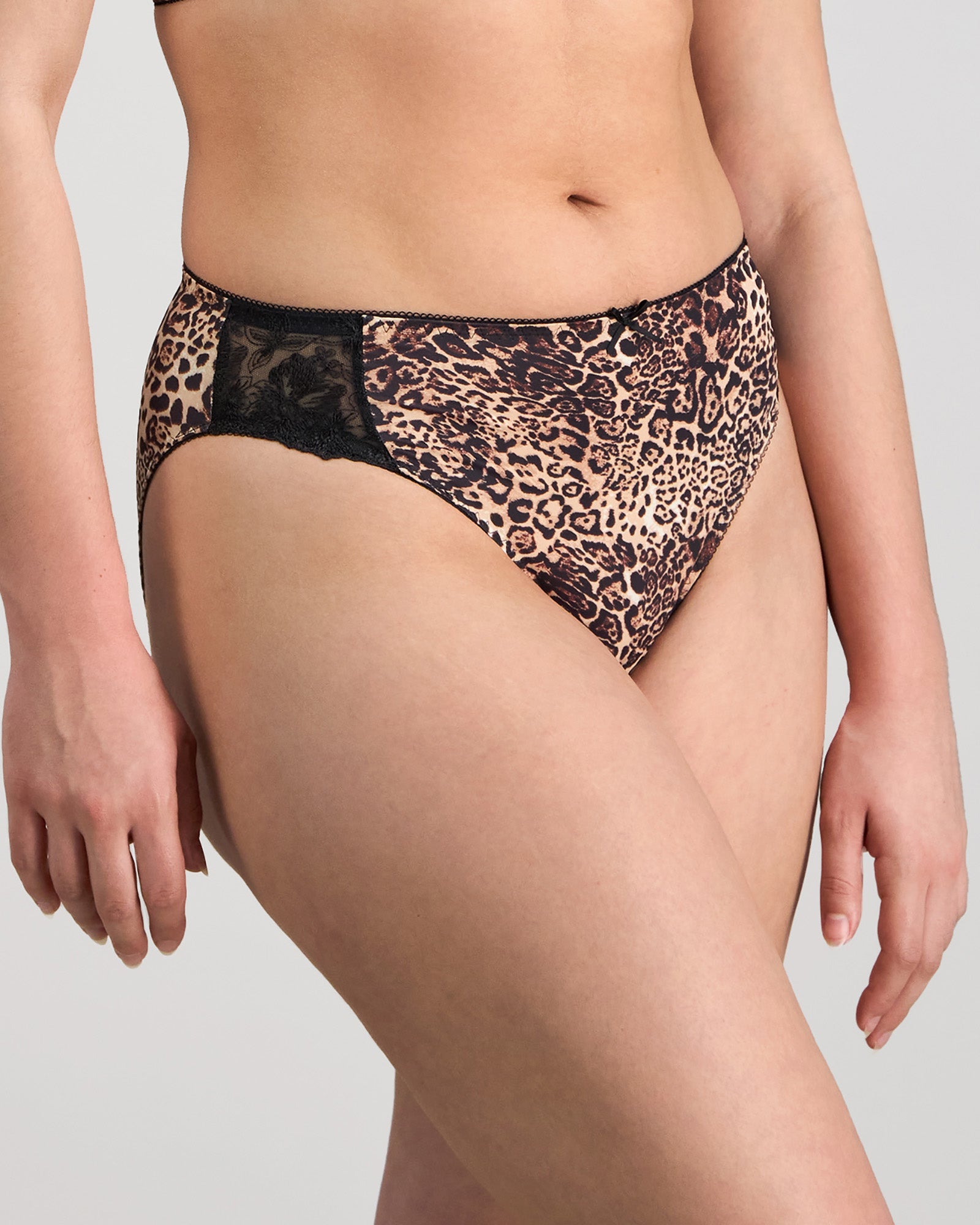 Model wears Violet Floral High Cut Brief in MYTHOS ANIMAL PRINT. On body side view