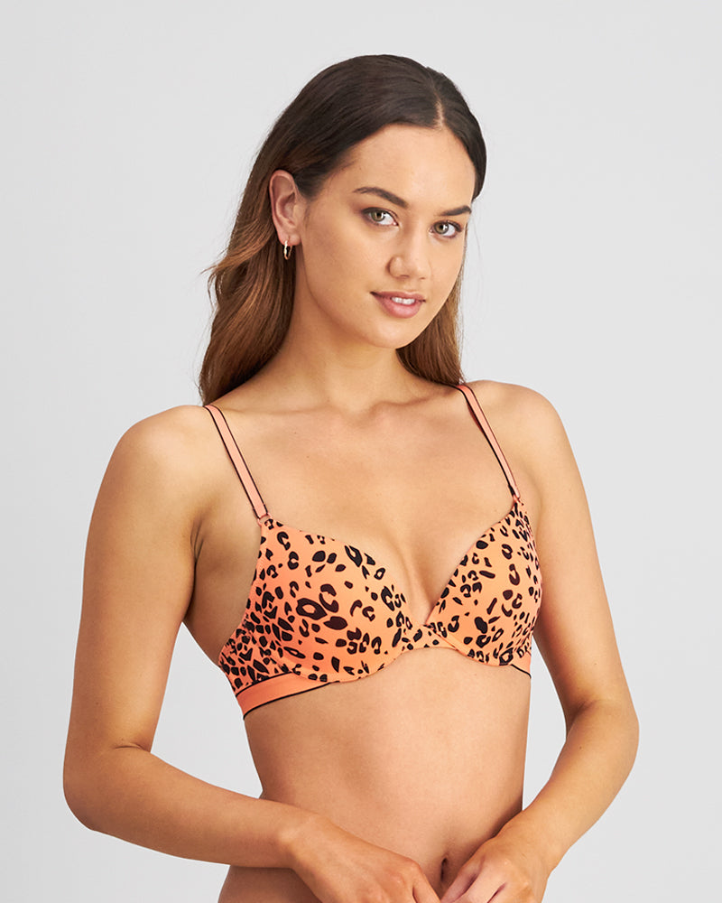 Model wears Uplift Me Push Up Bra in LIVING CORAL LEOPARD PRINT. On body side view