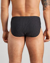 Model wears Cotton Stretch Mens Brief in BLACK PINSTRIPE. On body back view