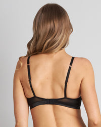 Model wears Lace Me Up Bralette in BLACK. On body back view