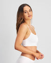 Model wears Simply Seamless Crop Top in WHITE. On body side view