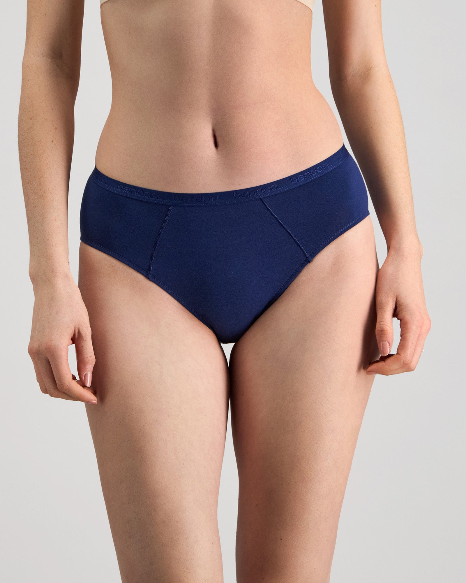 Model wears Body Cotton Bikini in Medieval Blue. On body front view