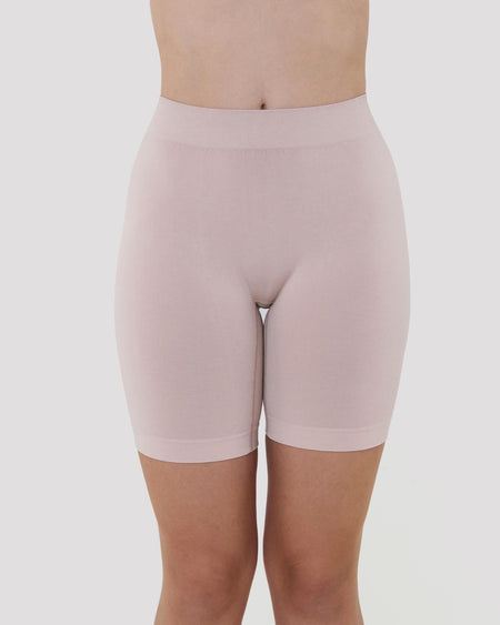 Model wears Smoothing Bodywear Chafer Short in CARAMEL. On body front view