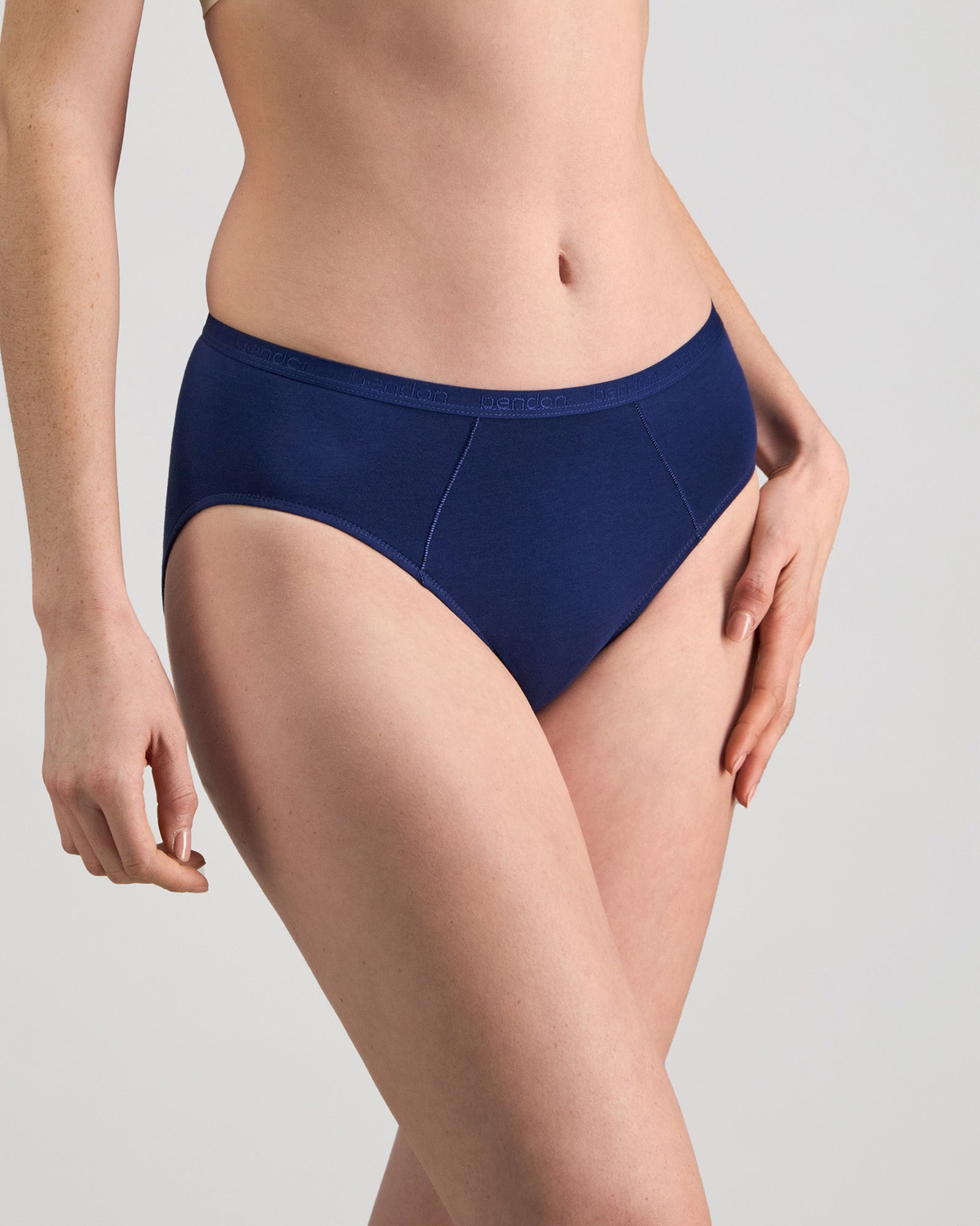 Model wears Body Cotton Bikini in Medieval Blue. On body side view