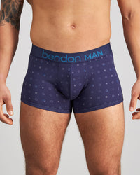 Model wears Retros Print Mens Trunk in INKY SPOT PRINT. On body front view